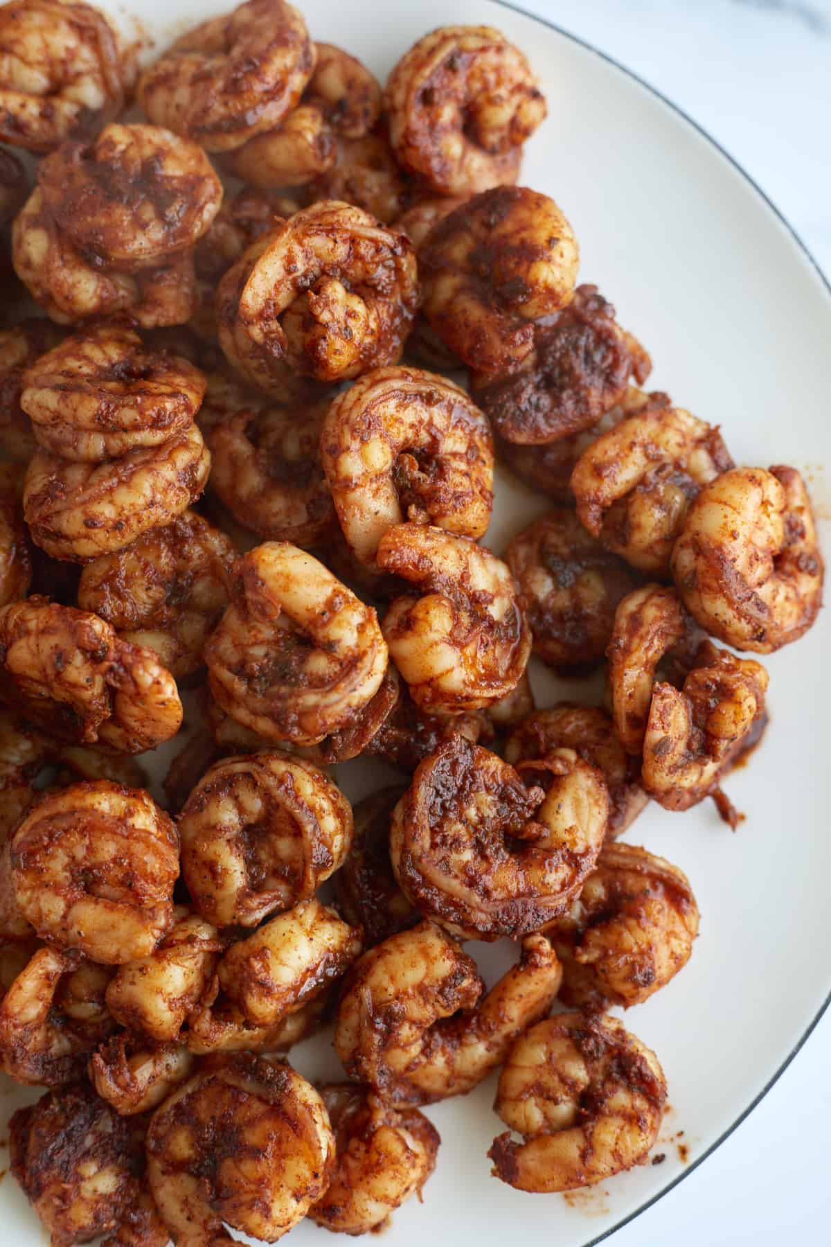 a bowl of cooked blackened shrimp.