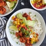 Blackened shrimp bowl topped with mango salsa and cilantro lime dressing.