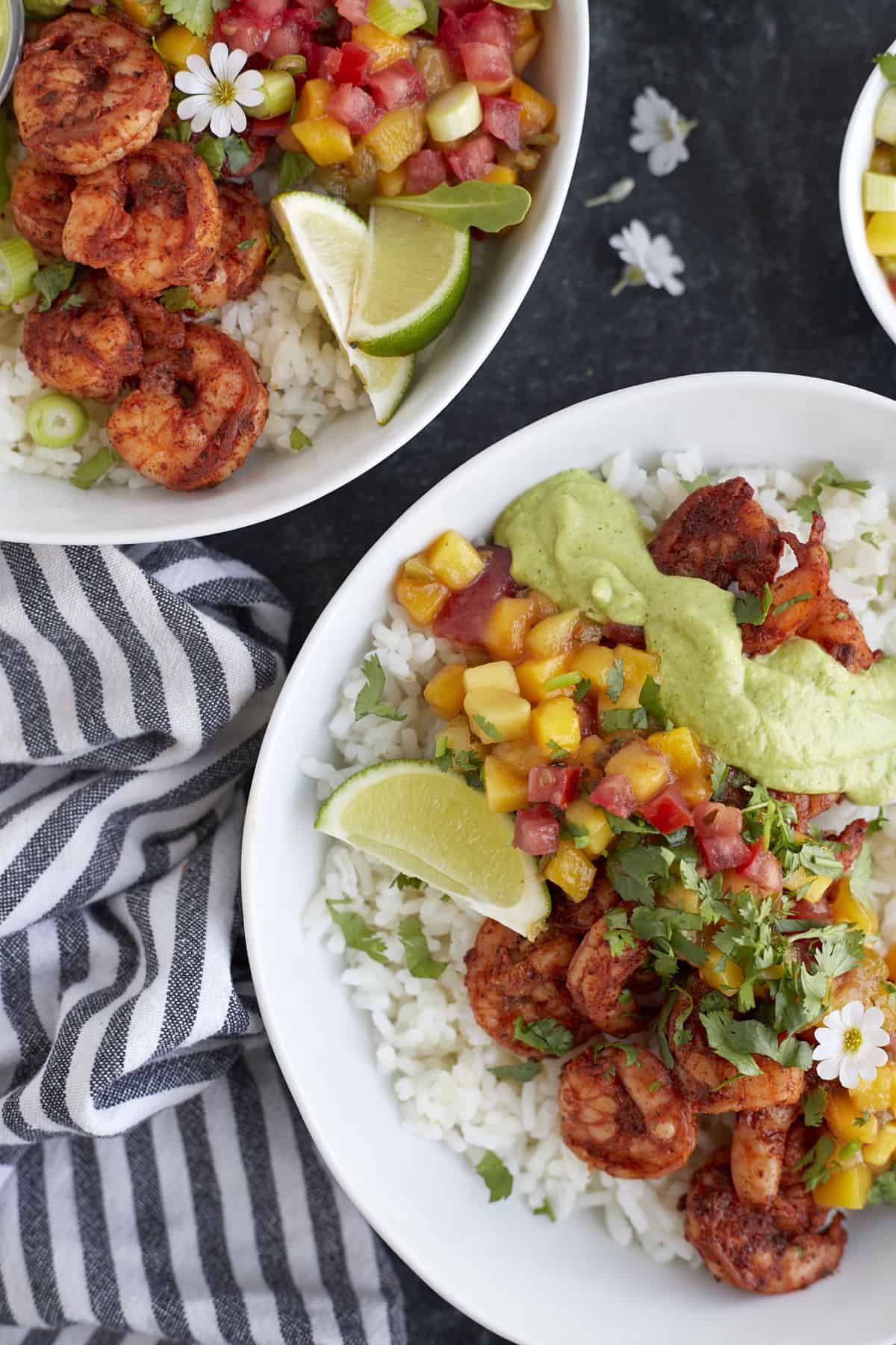 Blackened shrimp bowl topped with mango salsa and cilantro lime dressing.