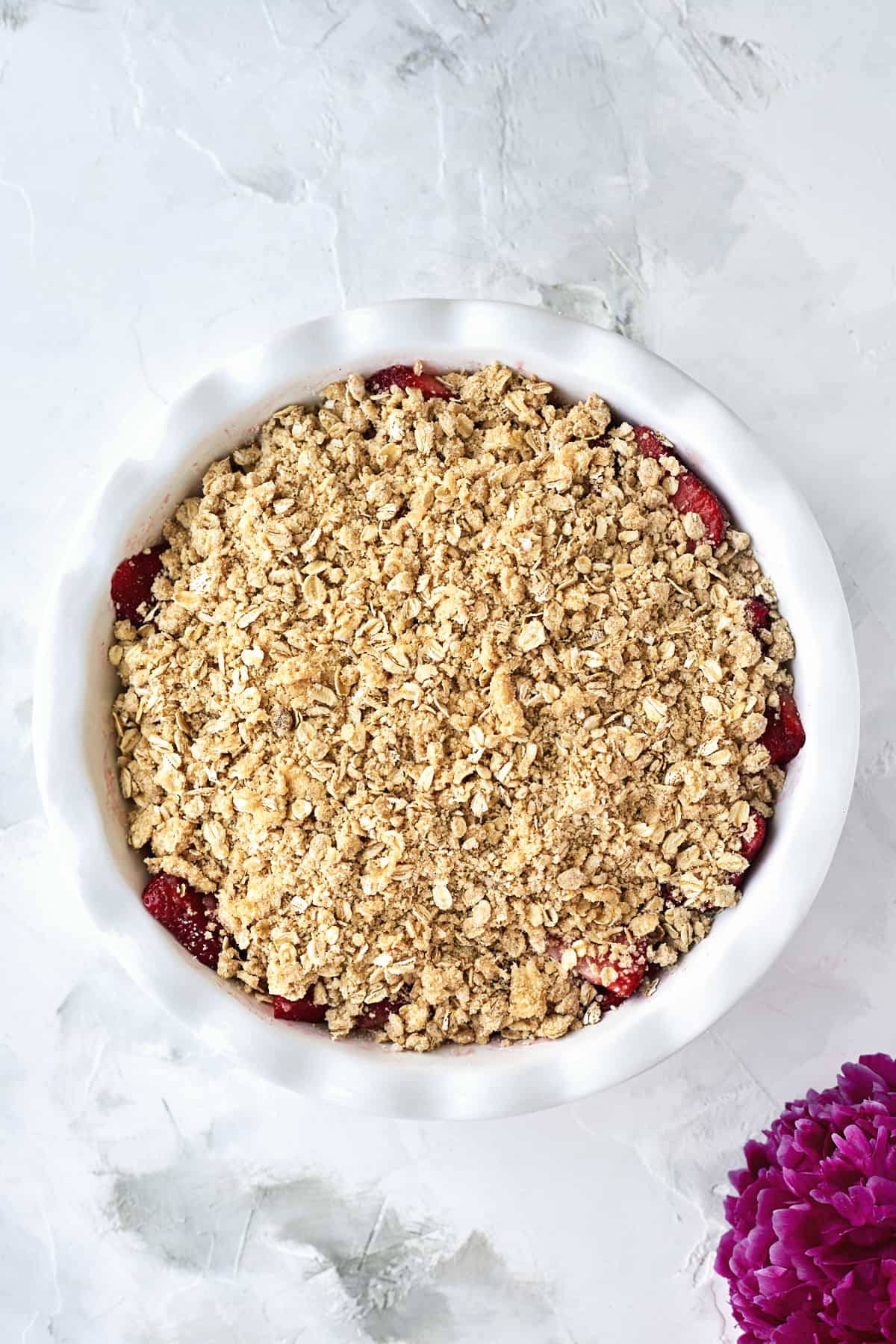 Strawberries in pie dish with oat crumble