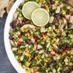large white bowl with cowboy caviar, limes, and gold spring spoons