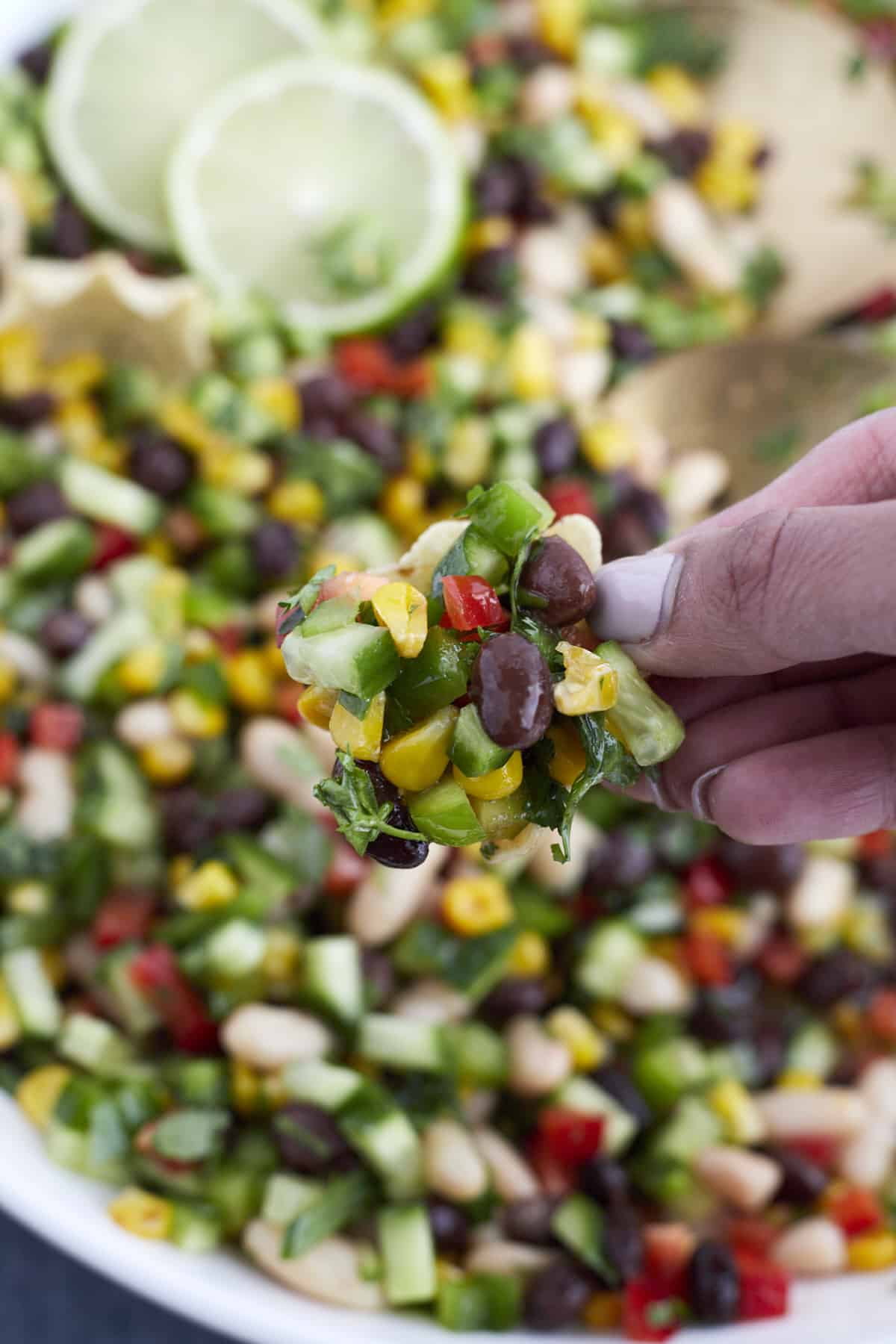 closeup scoop of cowboy caviar with tortilla scoops