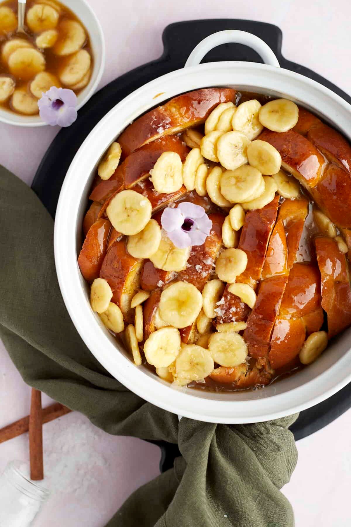 overhead image of bananas foster french toast topped with banana slices