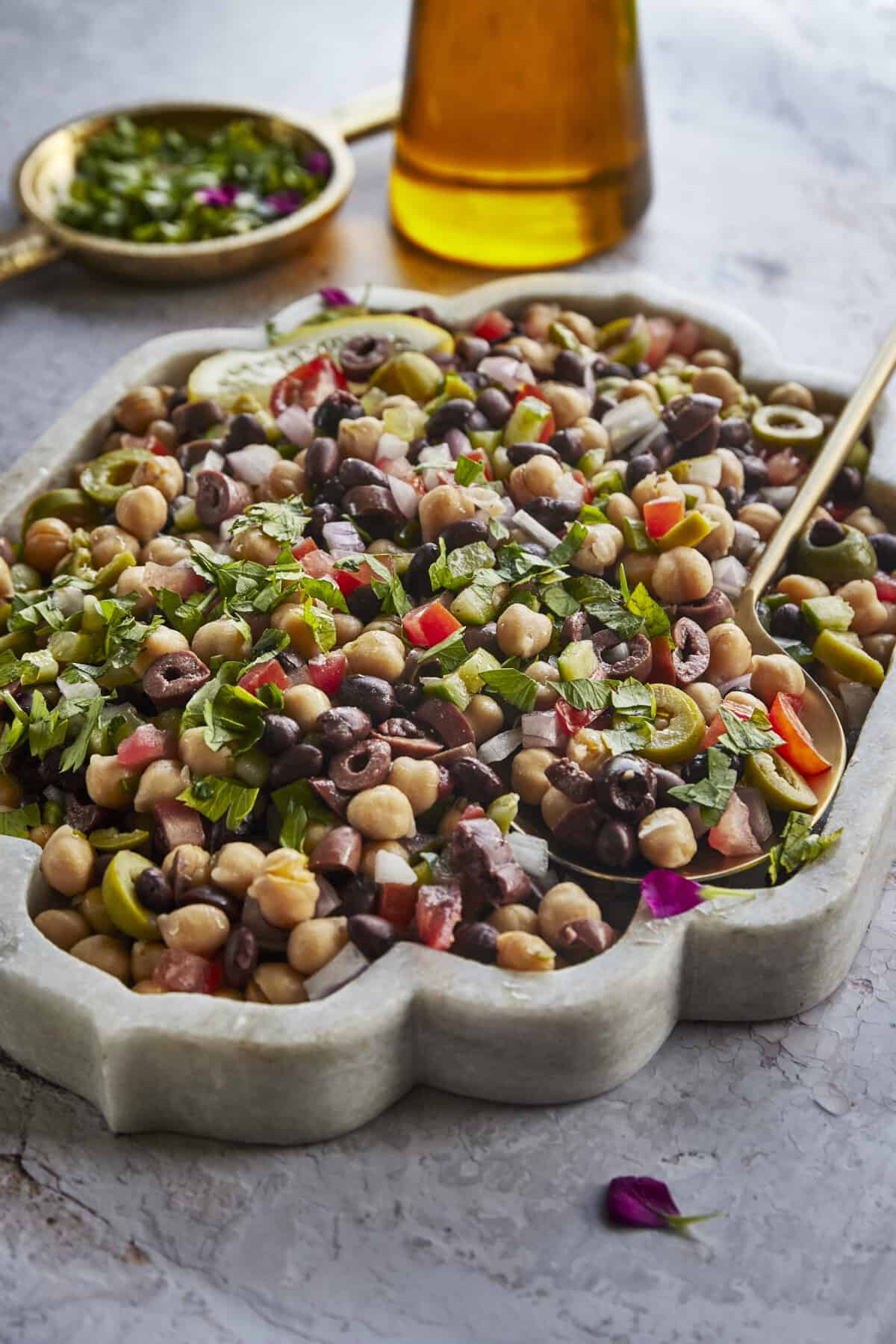 A bowl of Greek cowboy caviar with a spoon sticking out. 