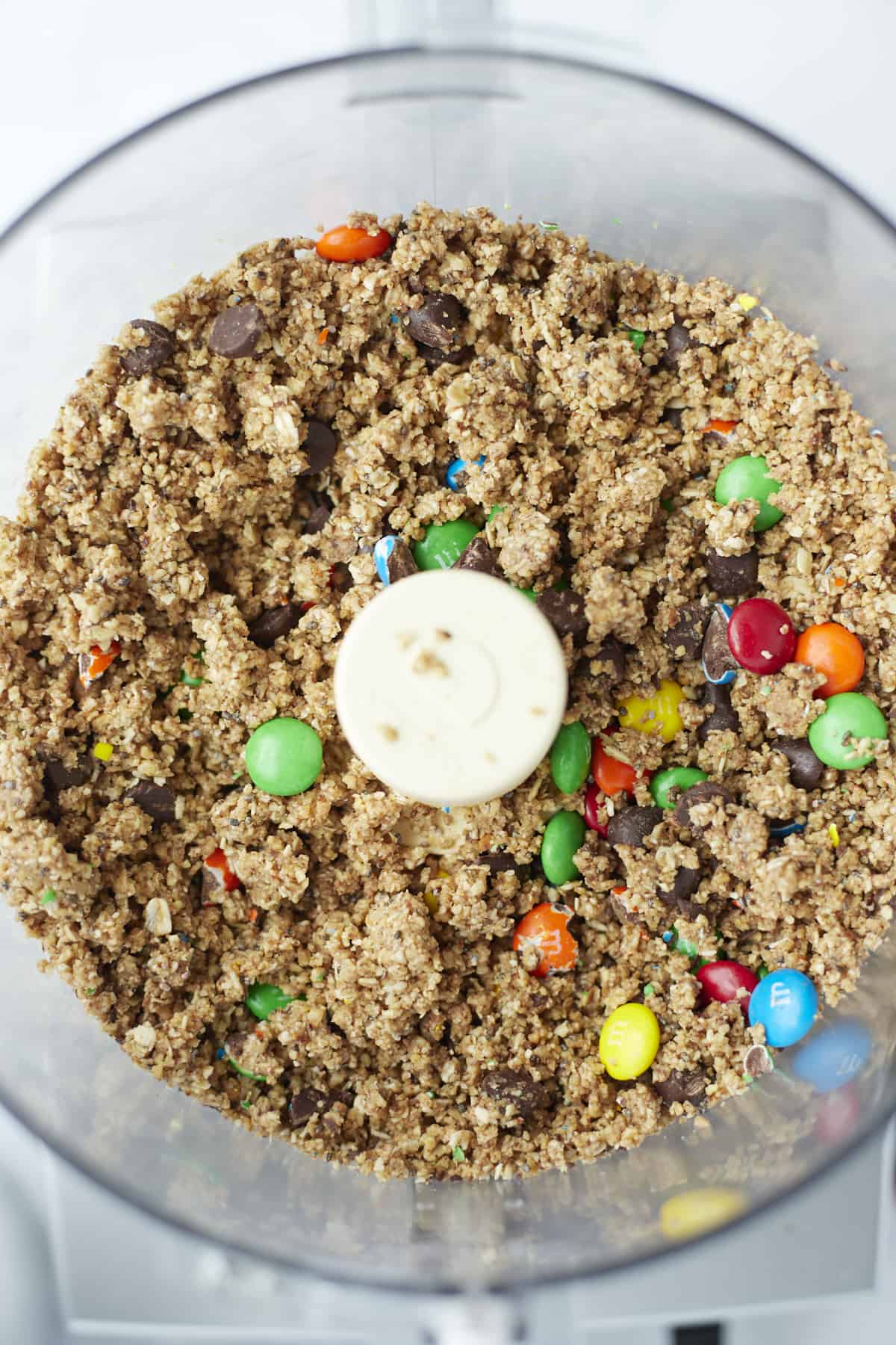 overhead image of monster cookie bar batter in a food processor