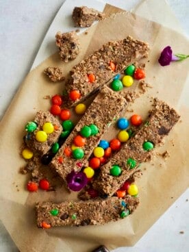 no-bake monster cookie bars on parchment paper.