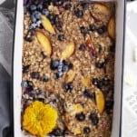 Overhead image of peach blueberry baked oats in a baking dish.