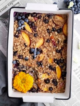 Overhead image of peach blueberry baked oats in a baking dish.