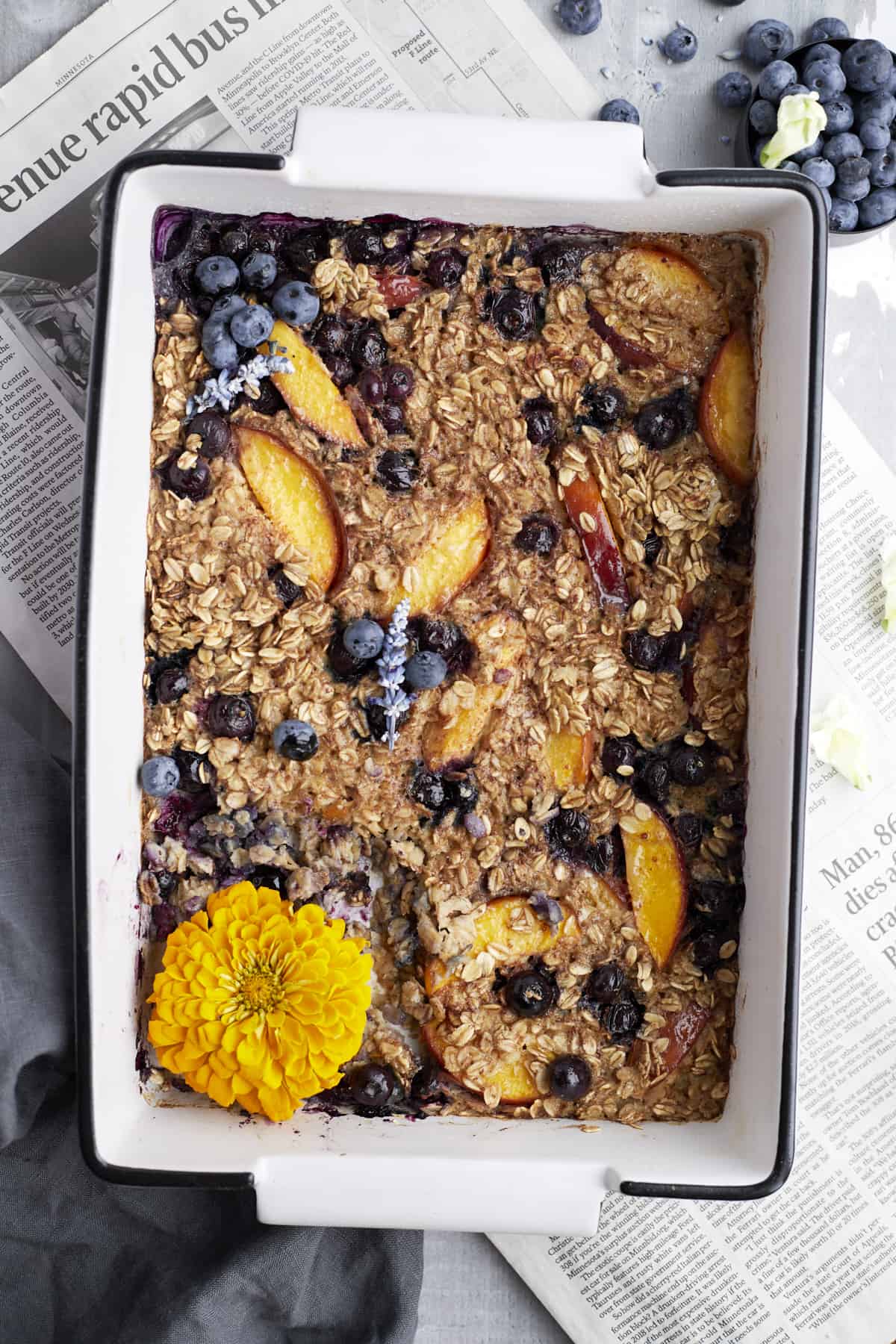 Overhead image of peach blueberry baked oats in a baking dish.