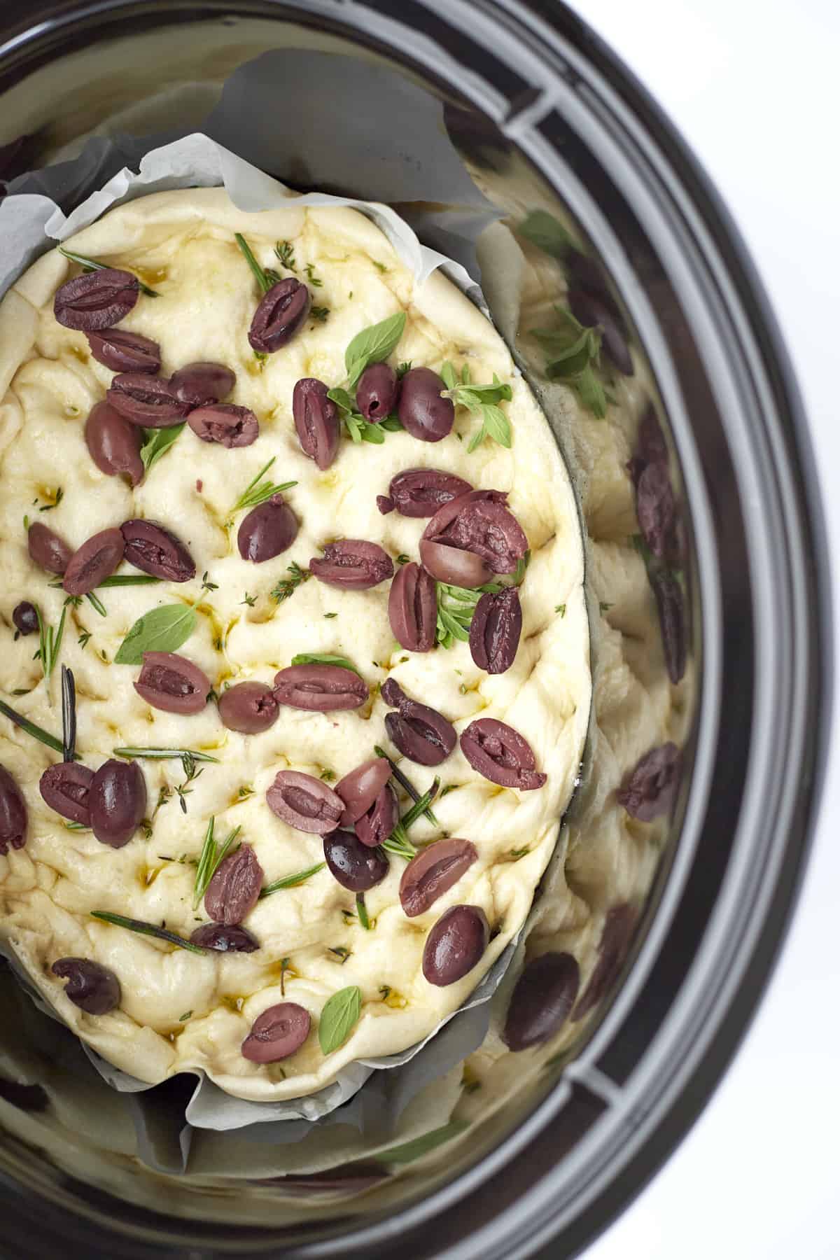 baked easy focaccia with olives in a slow cooker