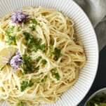 a bowl of one pot lemon pasta topped with fresh herbs