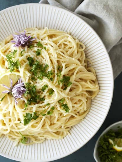 a bowl of one pot lemon pasta topped with fresh herbs