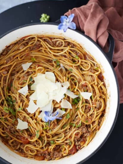 A pot full of one pot spaghetti recipe with ground beef topped with Parmesan cheese.