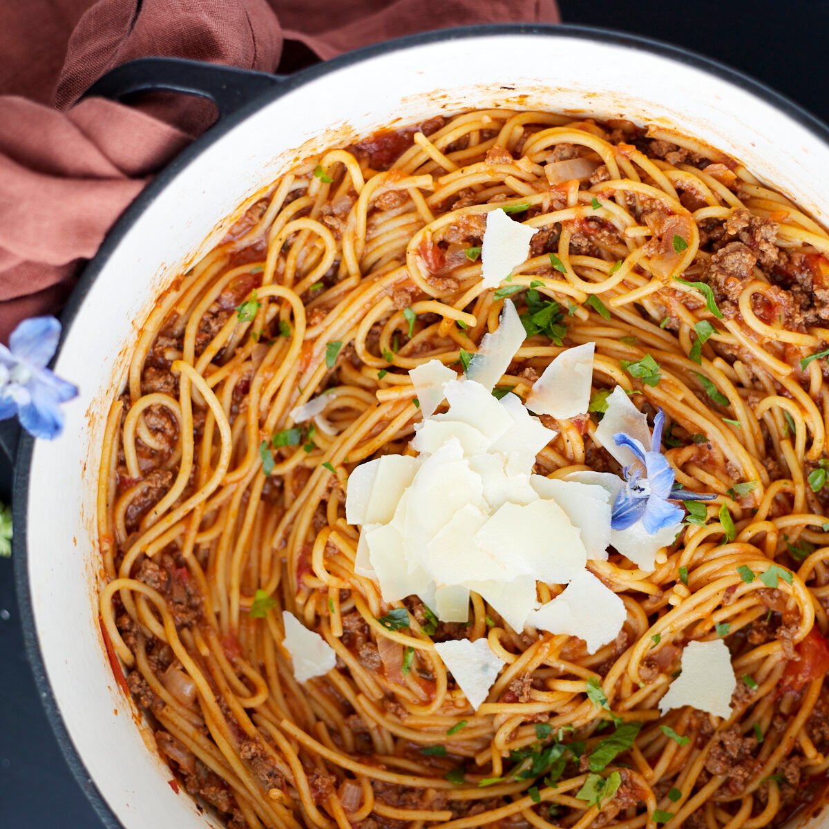 A pot full of one pot spaghetti recipe with ground beef topped with Parmesan cheese.