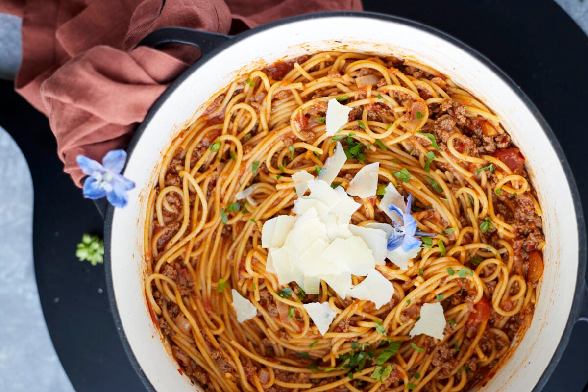 A pot full of one pot spaghetti recipe with ground beef topped with Parmesan cheese.
