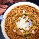 A pot full of one pot spaghetti recipe with ground beef topped with Parmesan cheese.