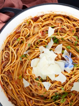 A pot full of one pot spaghetti recipe with ground beef topped with Parmesan cheese.