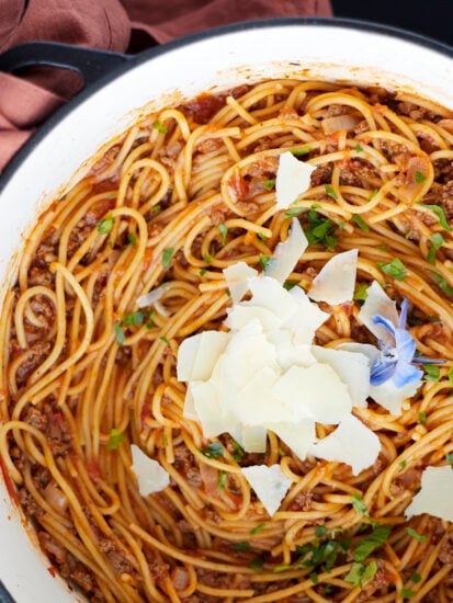 A pot full of one pot spaghetti recipe with ground beef topped with Parmesan cheese.