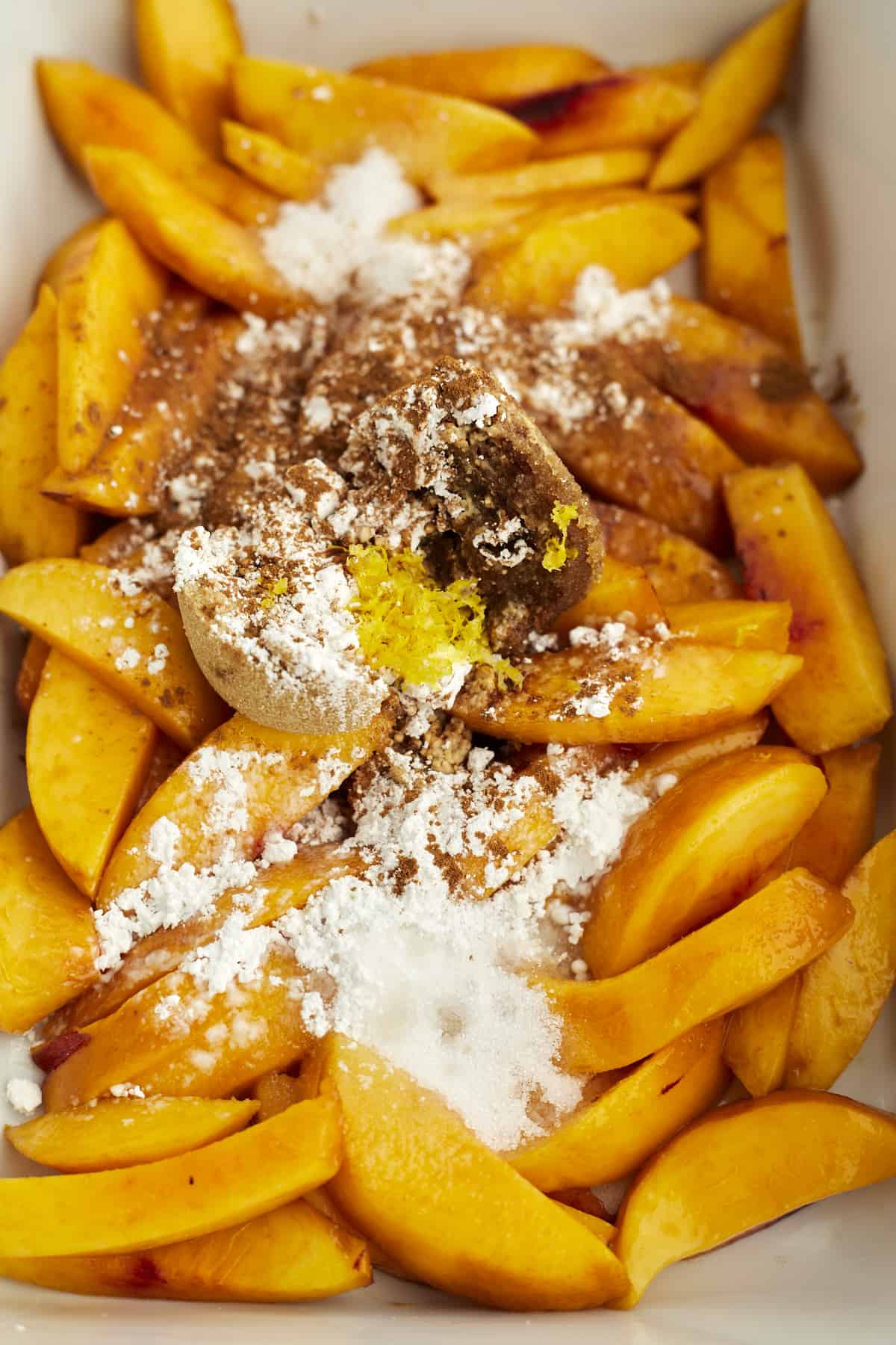 overhead image of peaches topped with cinnamon and sugar