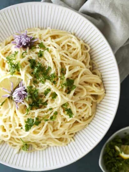 A bowl of one pot lemon pasta topped with fresh herbs.