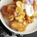 a plate of bananas foster french toast