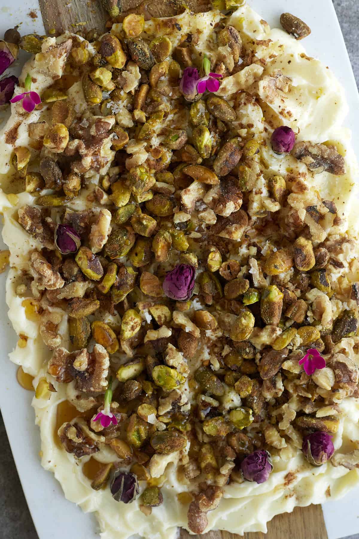 close up image of baklava butter with roasted walnuts, pistachios, honey, cinnamon, and salt