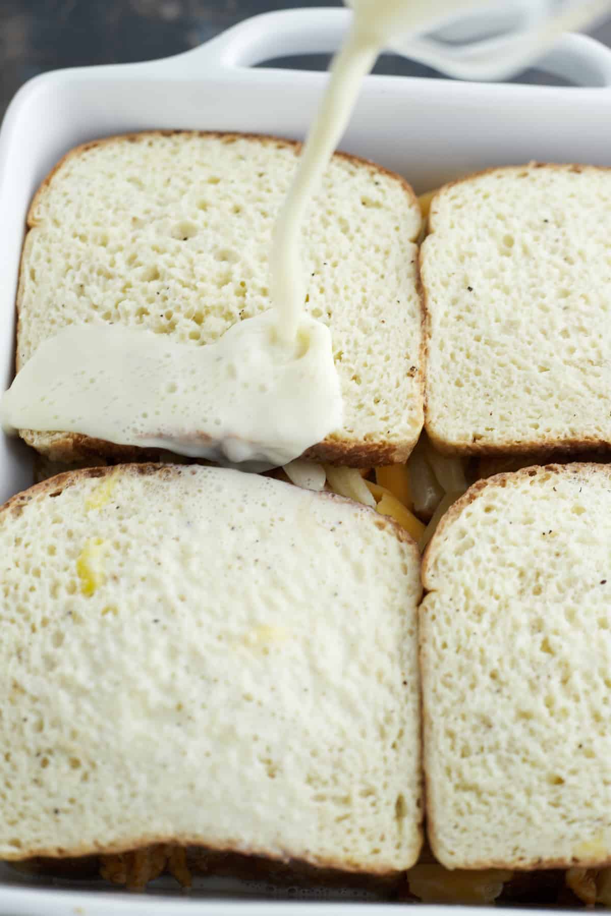 four unbaked fajita chicken sandwiches in a white square baking dish