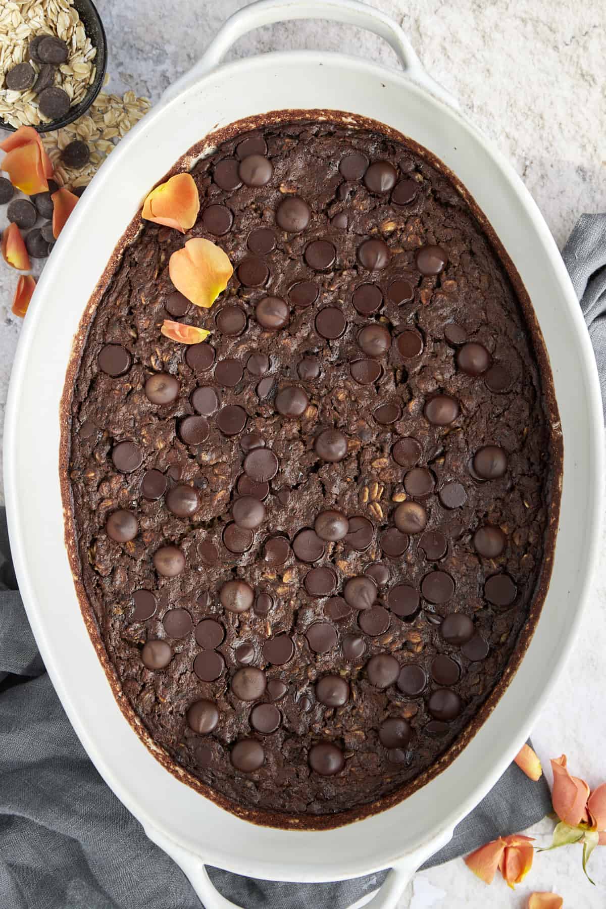 overhead image of baked chocolate oatmeal in an oval baking dish