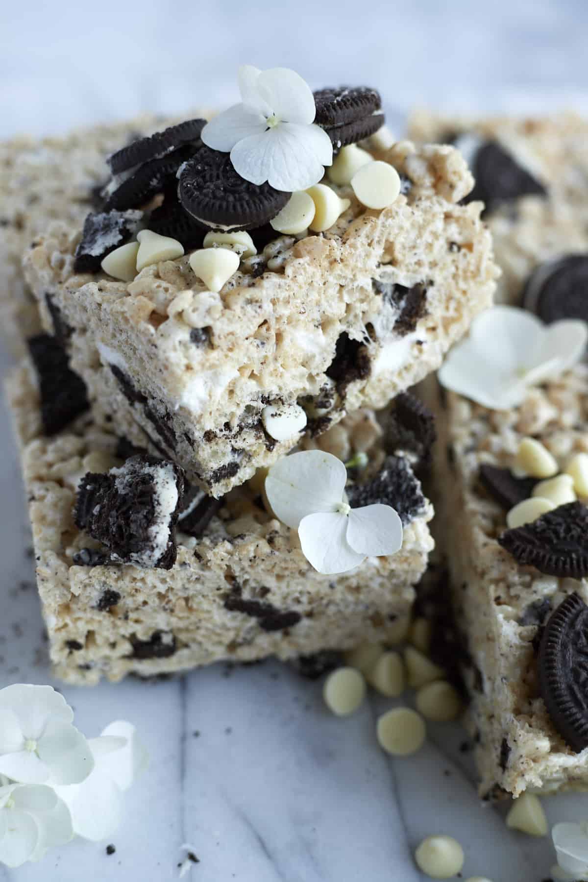close up image of Oreo Rice Krispie Treats topped with Oreo pieces and white chocolate chips