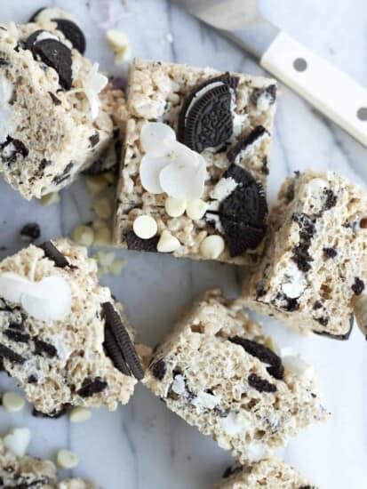 6 Oreo Rice Krispie Treats topped with white chocolate chips and Oreo chunks