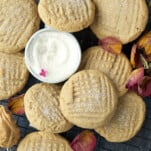 soft peanut butter cookies on a wire rack with a bowl of sugar in the center