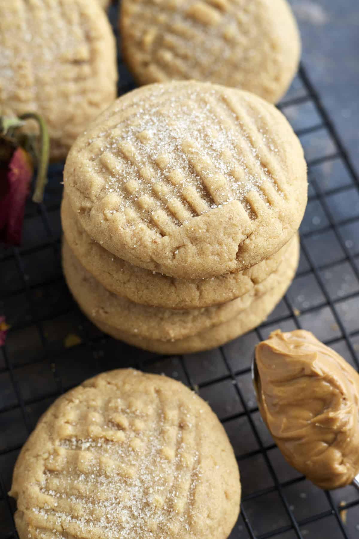 soft peanut butter cookies stacked on top of each other on a wire rack