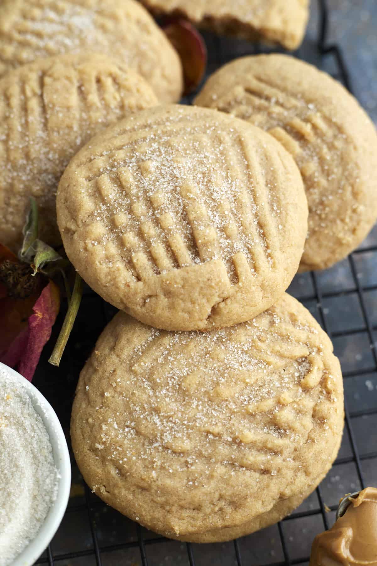 close up image of soft peanut butter cookies on a wire rack 