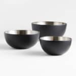 Three black stainless steel mixing bowls.