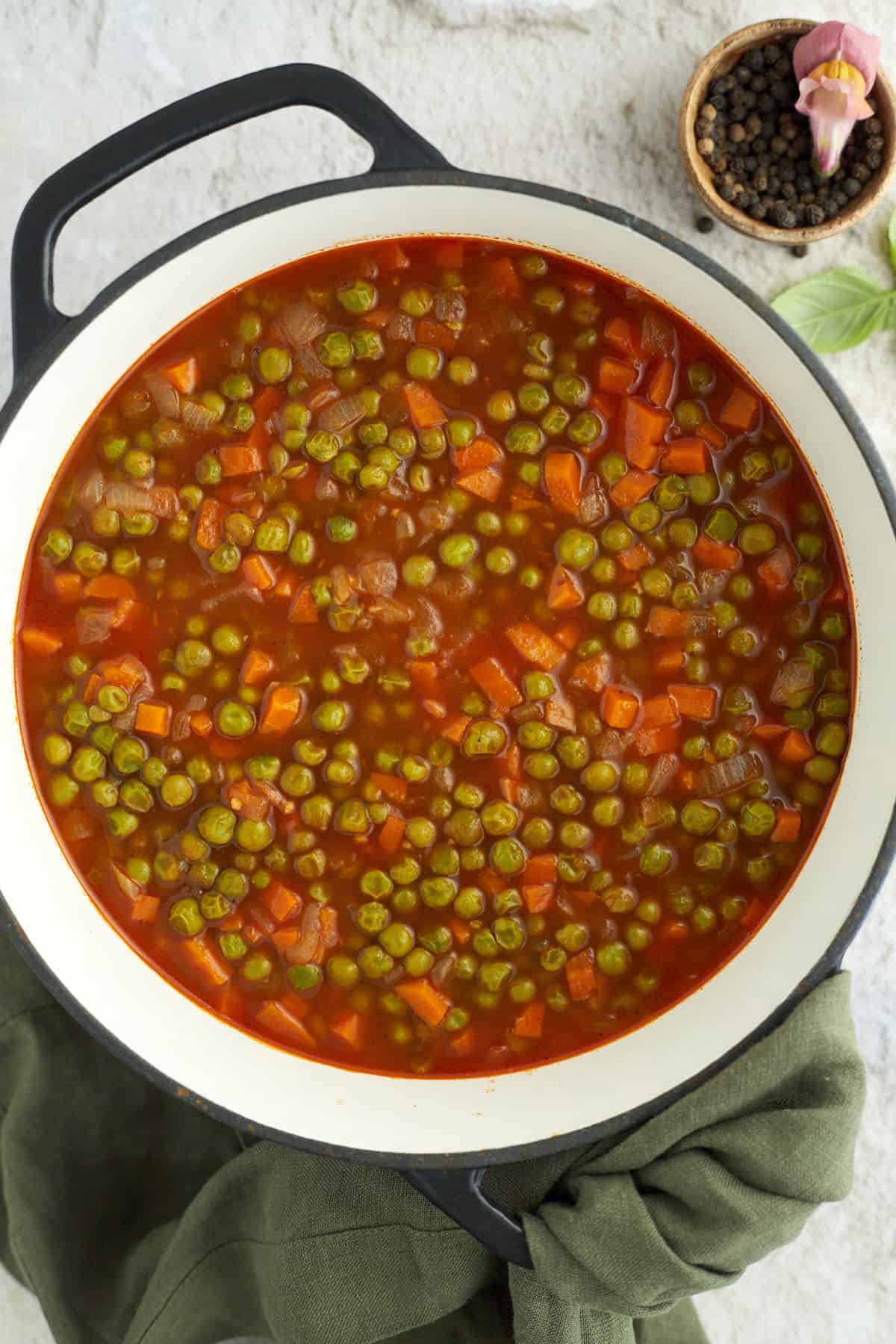 overhead image of pea and carrot vegetarian stew in a large pot