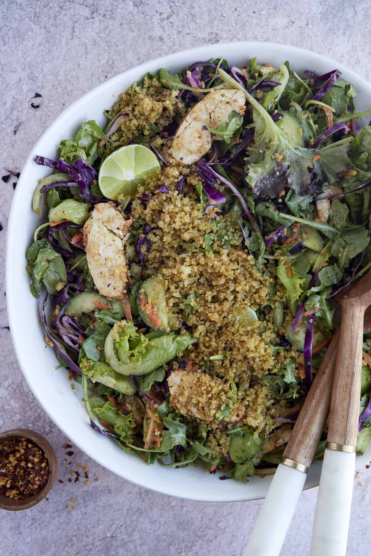 a bowl of crispy rice bowl SweetGreen copycat salad with serving tongs sticking out.