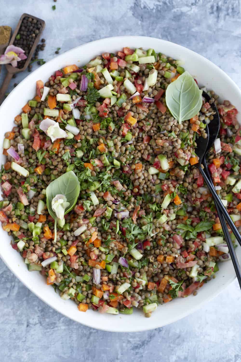 overhead image of a large white bowl full of lentil salad