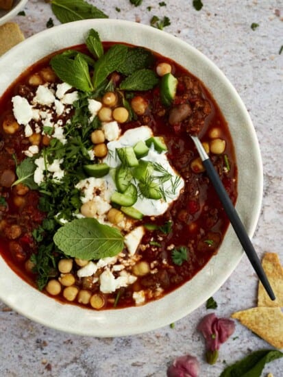 a bowl of Middle Eastern beef chili with a spoon dipped in