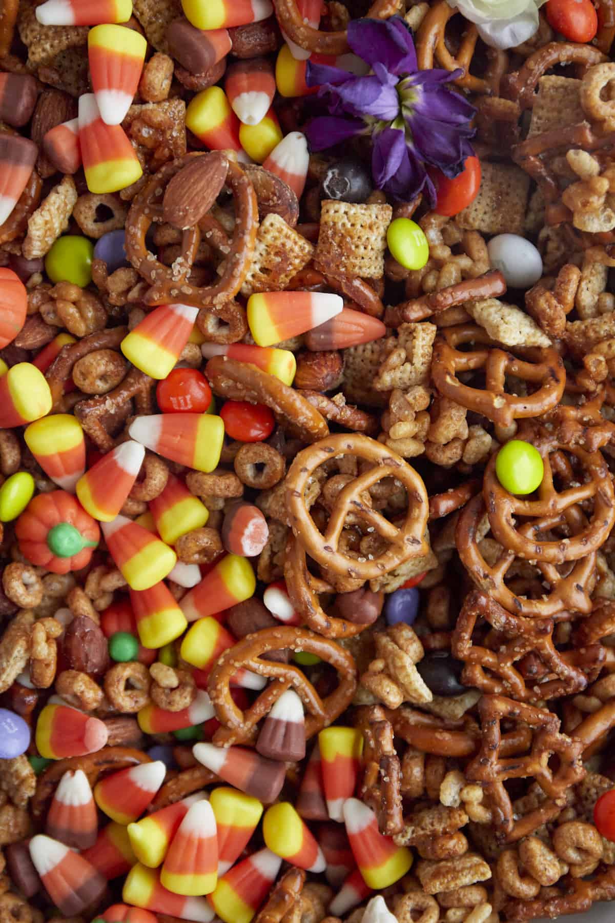 close up image of Halloween Snack Mix with cereal, pretzels, candy corn, and m&ms