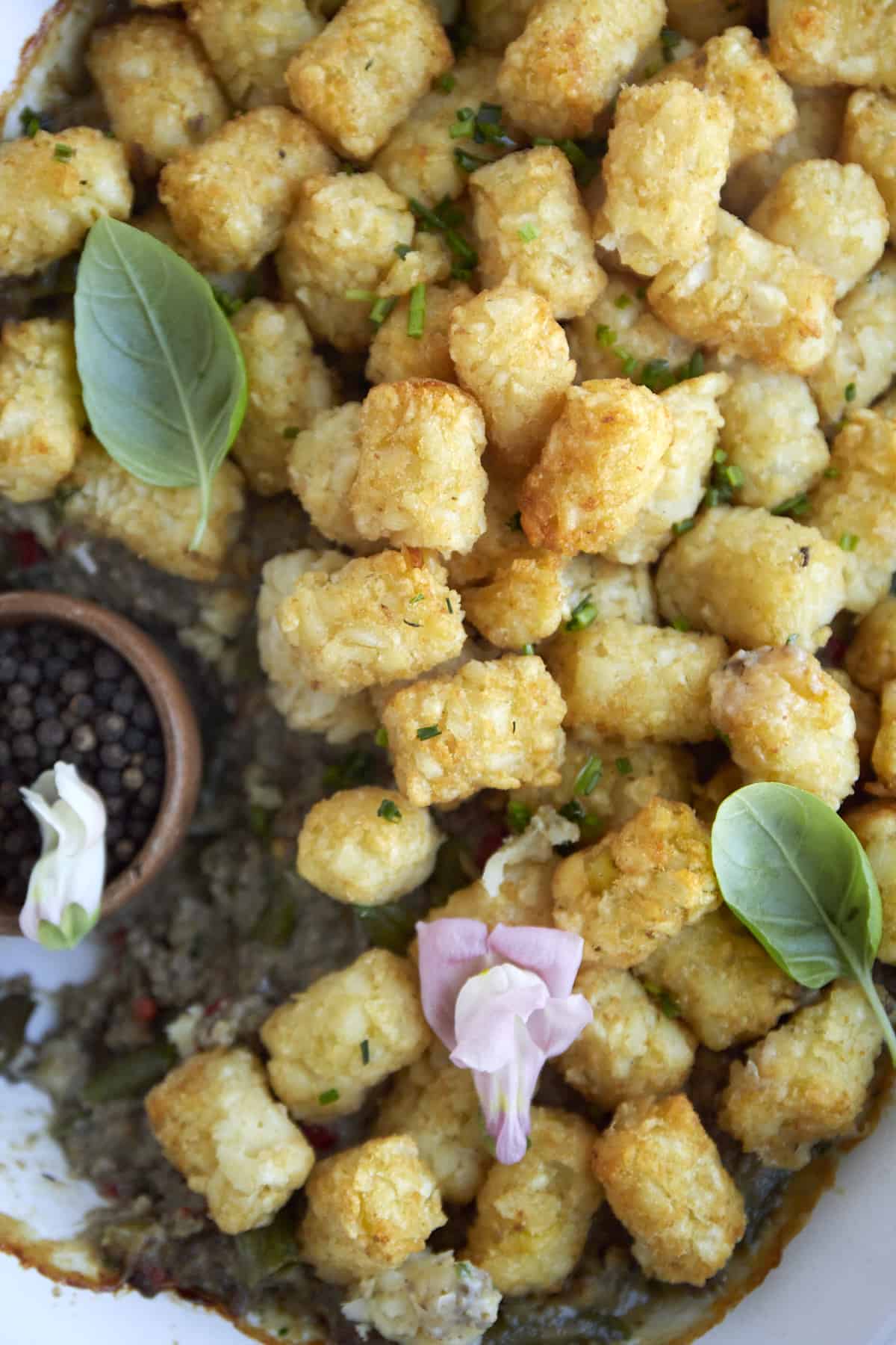 overhead image of tater tot hot dish with a serving scooped out