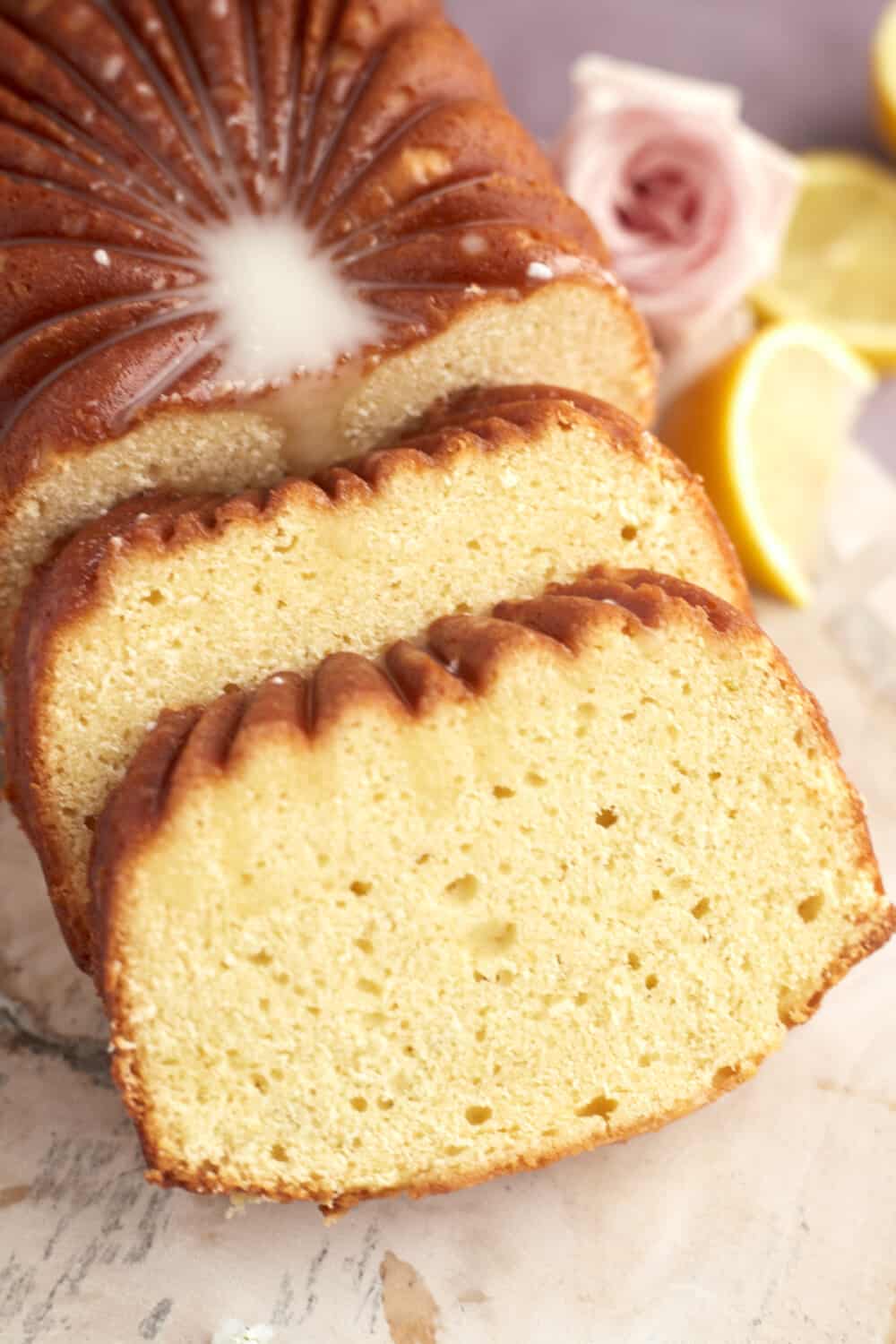 close up image of two sliced pieces of lemon loaf cake
