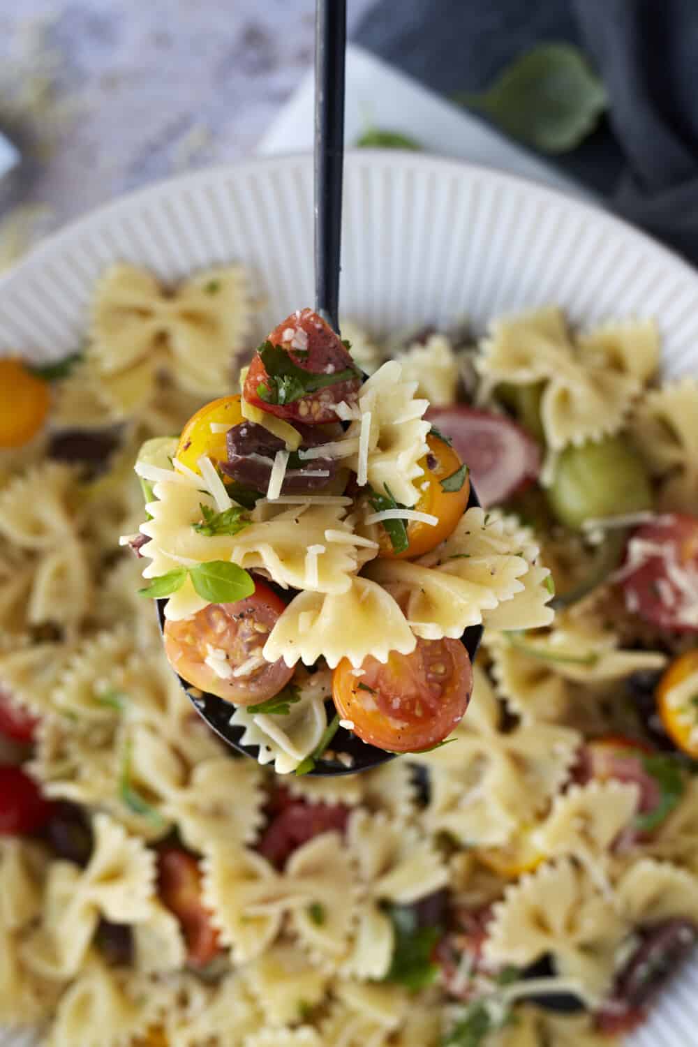close up image of warm Italian pasta salad on a spoon