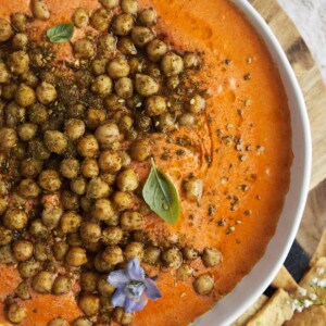 overhead image of a bowl of feta roasted red pepper dip topped with spiced crispy chickpeas