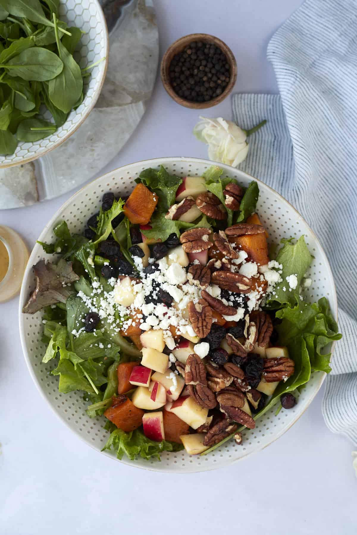 overhead image of a bowl full of roasted butternut squash salad