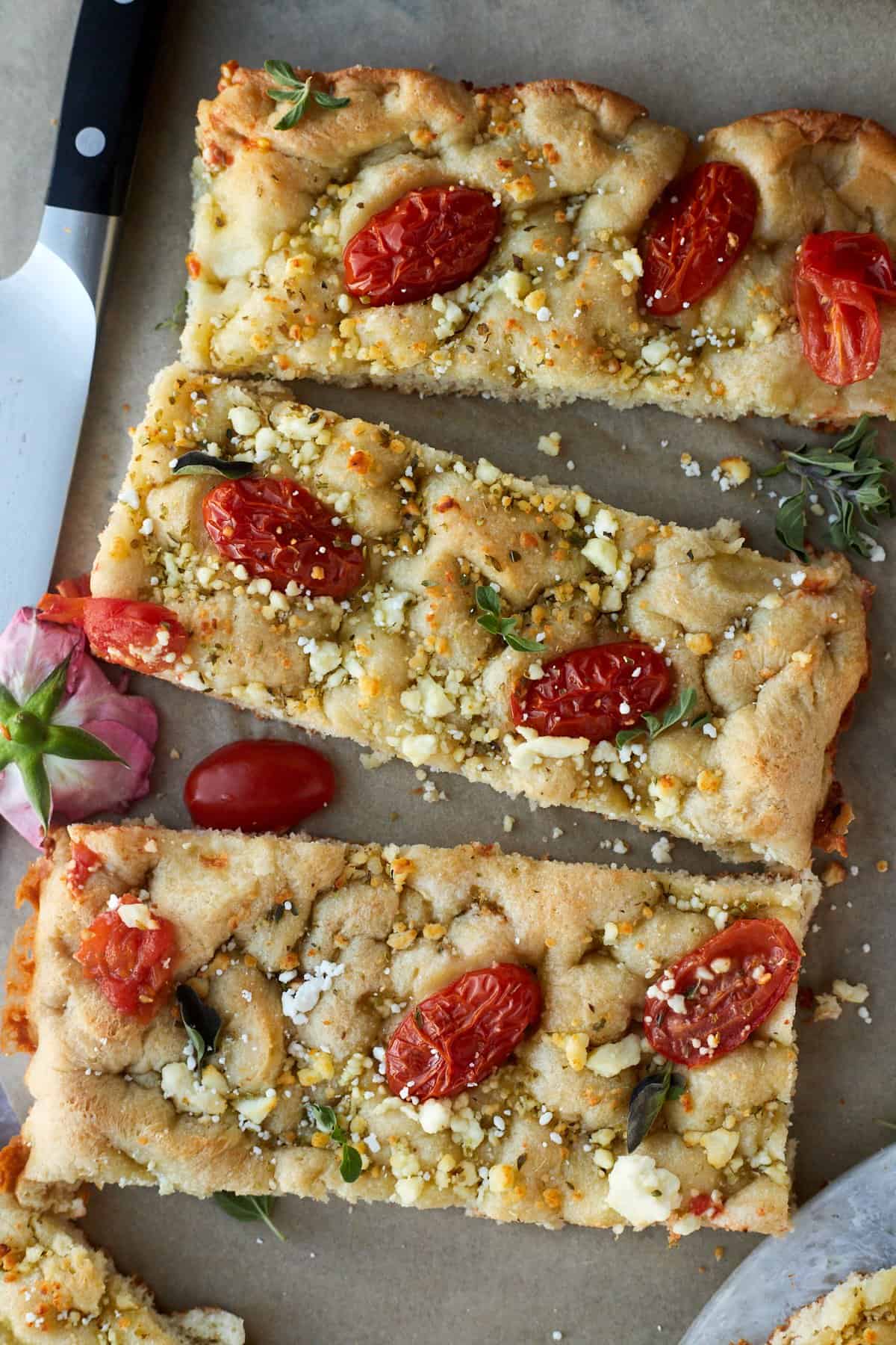 three sticks of easy focaccia bread with tomatoes and feta