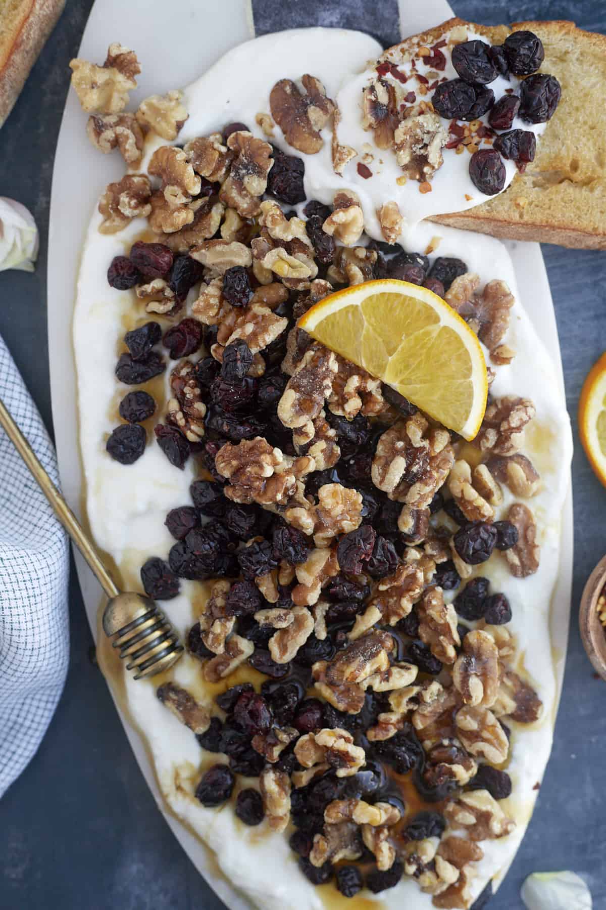 Cranberry and Walnut Whipped Feta Appetizer topped with a lemon wedge