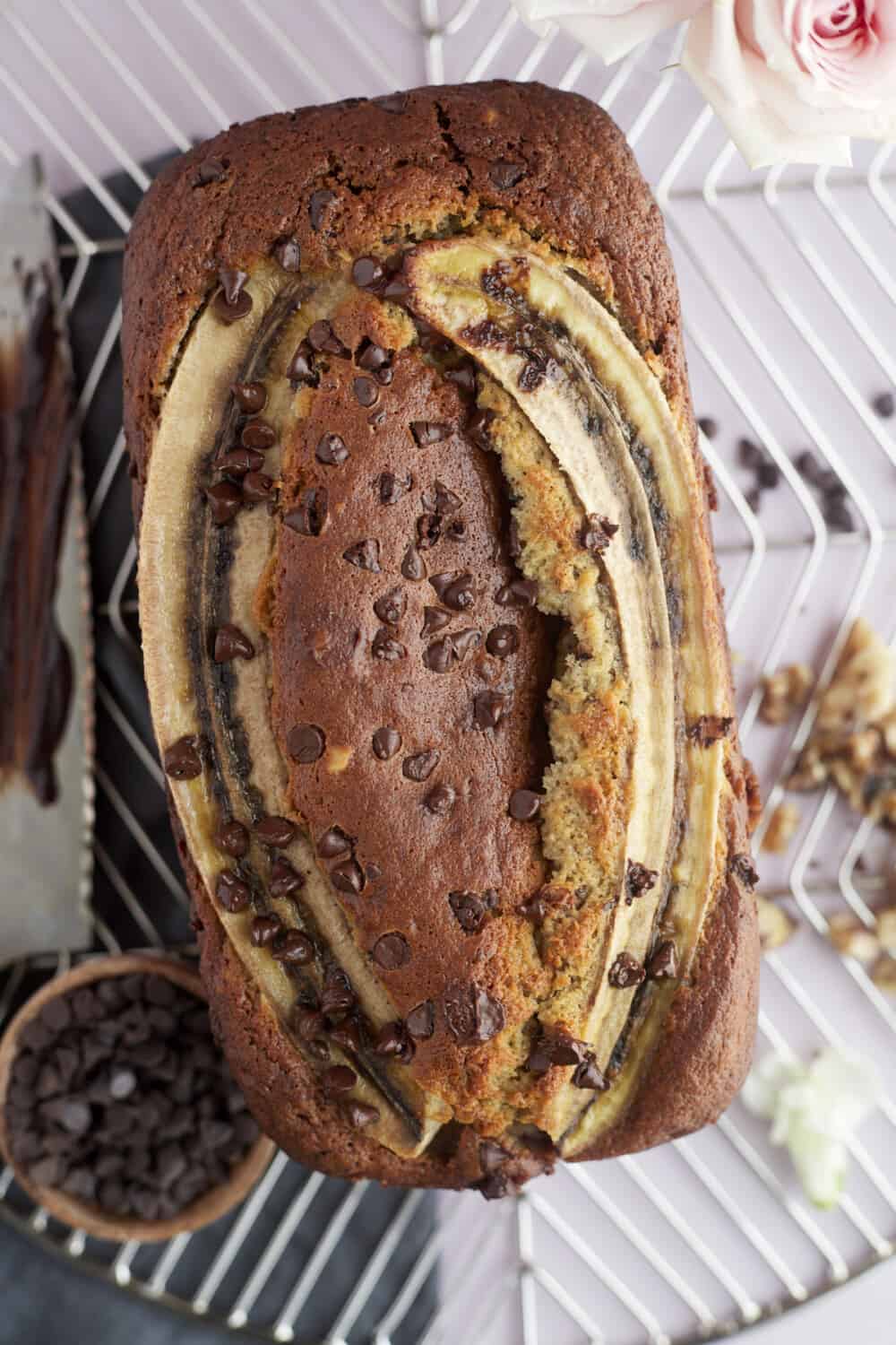 overhead image of a loaf of easy banana bread with sour cream topped with mini chocolate chips