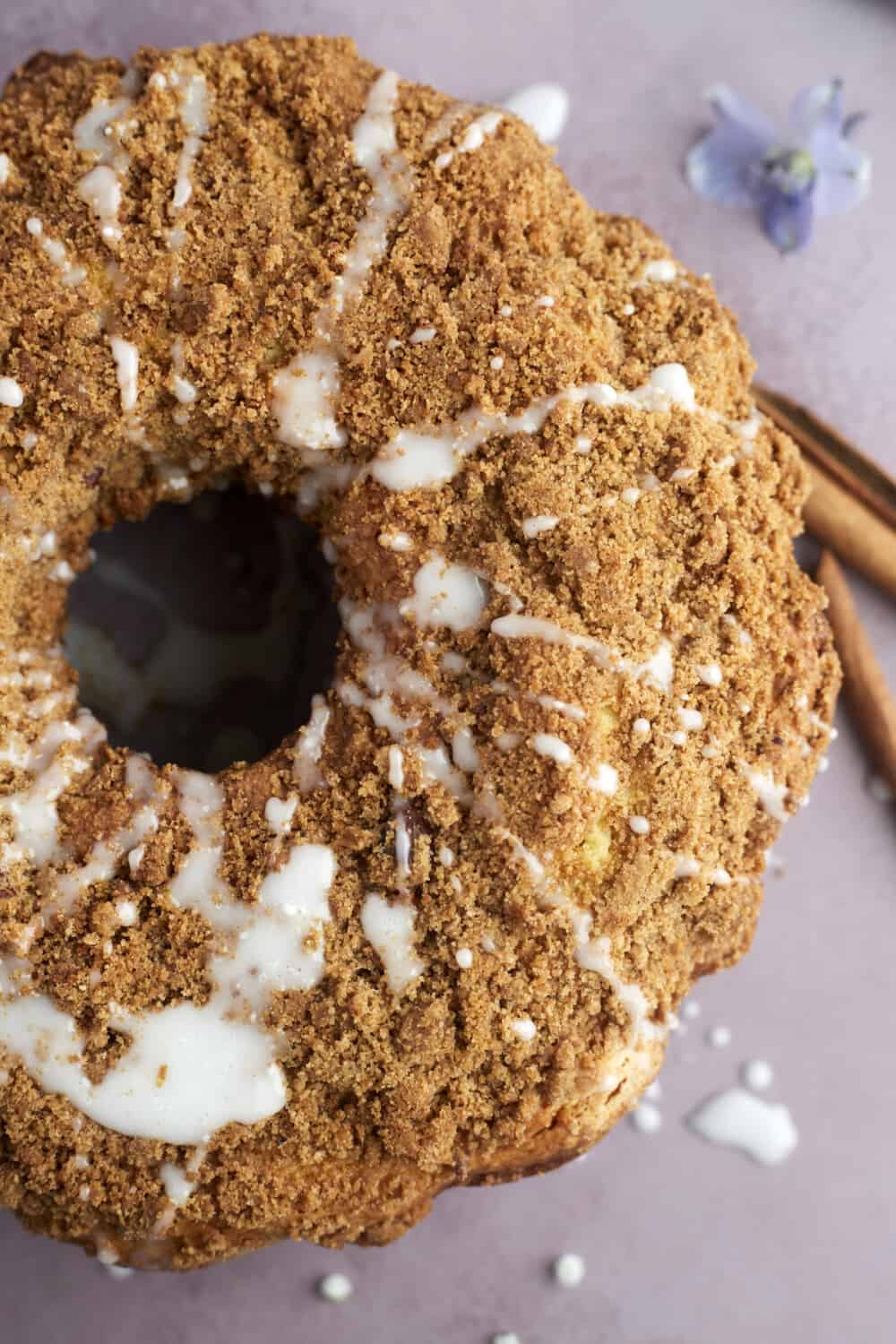 overhead image of a full sour cream coffee cake topped with a powdered sugar glaze