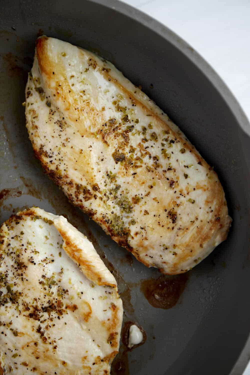seasoned cooked chicken breasts in a skillet