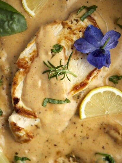 overhead image of creamy parmesan chicken in a skillet